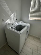 Thumbnail 10 of 11 - a washer and dryer in a laundry room