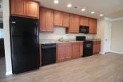 Thumbnail 15 of 24 - Kitchen with wood-like floors, granite counters, and new appliances