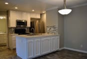 Thumbnail 12 of 29 - View of kitchen with recessed lighting, stainless appliances, tile backsplash and white cabinets
