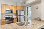 Thumbnail 1 of 29 - a kitchen with granite countertops and stainless steel appliances