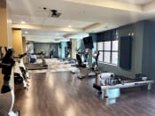 Thumbnail 19 of 29 - a spacious fitness center with cardio machines and weights