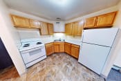 Thumbnail 1 of 17 - a kitchen with white appliances and wooden cabinets