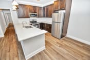 Thumbnail 33 of 61 - a kitchen with white countertops and wooden cabinets