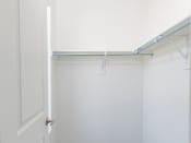 Thumbnail 26 of 30 - a white closet with a white door and white walls