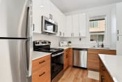 Thumbnail 11 of 30 - a kitchen with white cabinets and stainless steel appliances
