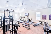 Thumbnail 5 of 13 - Greyson's Gate Apartments in North Dallas, TX offers its residents a fitness center with high energy equipment.