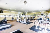 Thumbnail 16 of 22 - High energy fitness center fully equipped with fitness equipment in the Trinity Square Apartment Homes in North Dallas, TX!