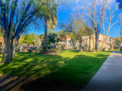 Thumbnail 18 of 22 - Community filled with lush landscaping and mature trees at La Hacienda Apartments in Tucson, AZ!