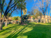 Thumbnail 9 of 22 - Community  filled with mature trees and lush landscaping at La Hacienda Apartments in Tucson, AZ!