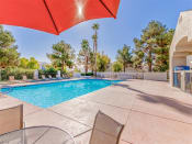 Thumbnail 14 of 41 - Resort pool umbrella at Country Club at Valley View Senior Apartments in Las Vegas, NV, For Rent. Now leasing 1 and 2 bedroom apartments.