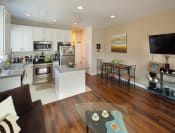 Thumbnail 21 of 64 - Apartment living room with kitchen and stainless steel appliances