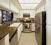 Thumbnail 46 of 64 - Apartment kitchen with built-in cabinets and stainless steel appliances