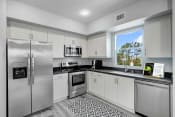 Thumbnail 10 of 18 - a kitchen with stainless steel appliances and a window