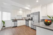 Thumbnail 11 of 61 - a kitchen with white cabinets and stainless steel appliances