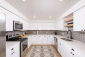 Thumbnail 18 of 50 - Fully-equipped kitchens with white shaker cabinetry and oil-rubbed bronze hardware package