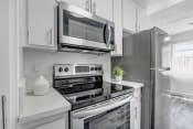 Thumbnail 1 of 44 - a kitchen with white cabinetry and stainless steel appliances
