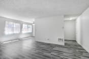 Thumbnail 5 of 44 - an empty living room with wood floors and white walls