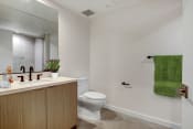 Thumbnail 34 of 38 - a bathroom with white walls and a green towel