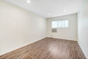 Thumbnail 9 of 63 - an empty living room with wood flooring and a window