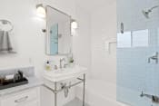 Thumbnail 5 of 19 - a white bathroom with a sink and a tub