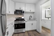 Thumbnail 30 of 72 - a kitchen with white cabinets and stainless steel appliances