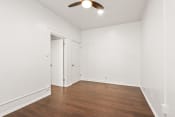 Thumbnail 12 of 21 - a bedroom with hardwood floors and white walls