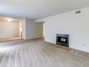 Thumbnail 9 of 21 - Living space at Ashley Pointe Apartments with a wood burning fireplace