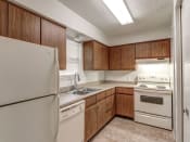 Thumbnail 1 of 21 - Townhome kitchen at Ashley Pointe Apartments with white appliances and lots of cabinets