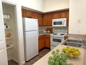 Thumbnail 11 of 15 - Liberty Landing Apartments Heathrow Floor Plan Kitchen with pantry, refrigerator, stove and sink. West Jordan, Utah.