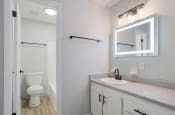 Thumbnail 36 of 70 - a primary bedroom bathroom with a smart mirror, sink vanity, toilet, and tub/shower