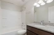 Thumbnail 46 of 70 - a bathroom with a sink toilet and bathtub in apartment at The Onyx Hoover