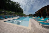 Thumbnail 16 of 24 - in-water loungers and deck chairs surrounding the pool at Canopy Park Apartments, Pelham