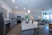 Thumbnail 19 of 24 - An open concept kitchen and living room in an apartment at Canopy Park Apartments, Pelham