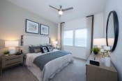 Thumbnail 22 of 24 - a spacious apartment bedroom with large windows, plush carpeting, and model decor at Canopy Park Apartments, Pelham, 35124