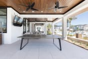 Thumbnail 18 of 48 - a ping pong table under ceiling fans at a relaxation deck at Lake Nona Concorde