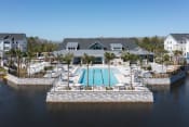 Thumbnail 46 of 48 - Lake Nona Concorde's pool, sundeck, and clubhouse beside the pond