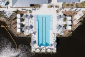 Thumbnail 47 of 48 - an aerial view of the pool and sundeck beside the pond at Lake Nona Concorde