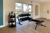 Thumbnail 30 of 30 - Fitness center with free weights, weight bench, and kettle bells  at Huntsville Landing Apartments, Huntsville, AL, 35806