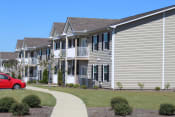 Thumbnail 13 of 18 - Neatly kept exteriors of Southbrook Apartment Homes buildings with lush landscaping