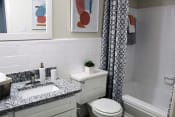 Thumbnail 18 of 30 - large bathroom with granite vanity, tile, tub, shower, and toilet  at Huntsville Landing Apartments, Huntsville, AL, 35806