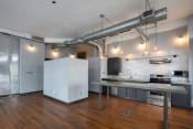 Thumbnail 1 of 24 - Kitchen with stainless steel appliances, updated lighting, hardwood at Jemison Flats, Birmingham, 35203