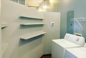 Thumbnail 8 of 24 - large laundry room with built-in shelving and appliances at Jemison Flats, Birmingham