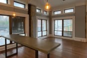 Thumbnail 4 of 24 - Spacious living area with floor to ceiling windows and hardwood floors at Jemison Flats, Birmingham, AL, 35203