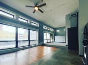 Thumbnail 9 of 24 - large windows in loft with ceiling fan and hardwood and concrete floors at Jemison Flats, Birmingham, AL, 35203