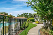 Thumbnail 5 of 32 - Poolside Walking Trail at The Oasis Apartments, Florida
