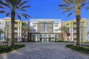 Thumbnail 41 of 44 - Exterior of Residences at The Green clubhouse with towering palms