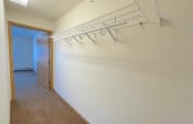 Thumbnail 19 of 24 - a large walk-in closet with built-in wire shelving in an Algonquin Manor Apartment home