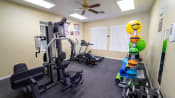 Thumbnail 15 of 16 - Fitness center equipped with strength training equipment, cardio equipment, and yoga equipment