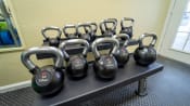 Thumbnail 14 of 16 - Fitness center equipped with kettlebells