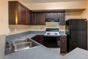 Thumbnail 11 of 22 - Kitchen breakfast bar, double basin sink, and dark espresso cabinetry